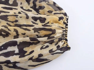 Detailed view of lightweight chiffon fabric with leopard print and elastic smocked cuff