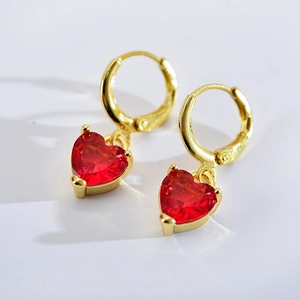 Detailed view of gold hoop earrings with vibrant red heart-shaped zircon drop pendants