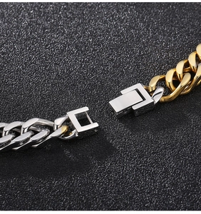 Close-up of two-tone gold and silver Cuban link necklace with a sleek folding clasp