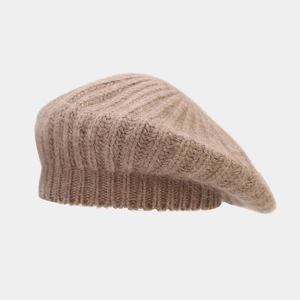 Detailed macro view of the knitted texture on a warm camel rabbit fur beret