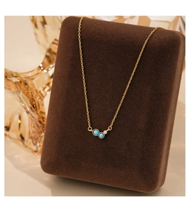 Close-up of S925 silver turquoise necklace displayed on a luxury dark brown velvet stand