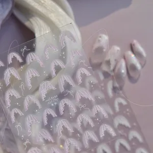 Detailed view of pink lace drapery nail art stickers with white bow and star patterns