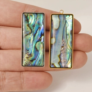 Detail of rectangular abalone shell pendants with gold and silver stainless steel frames