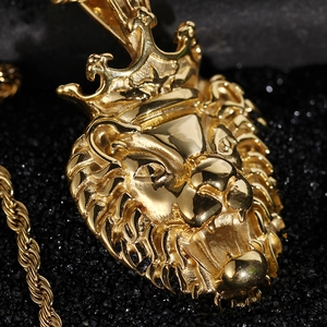 Macro shot of gold lion head pendant with crown on rope chain over luxury dark background