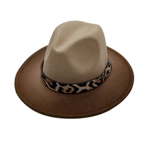 Detail of the dual-tone felt fedora hat featuring a leopard print band and gold buckle