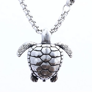 Vintage silver turtle pendant necklace with detailed shell texture on a metal box chain