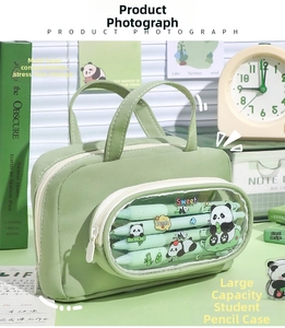 Macro shot of green pencil case with clear window and multi-layer panda storage compartments