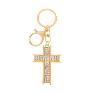 Close-up of golden cross keychain with shimmering rhinestones and a lobster clasp
