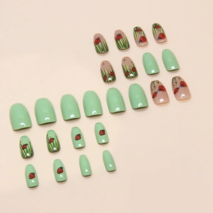 Ladybug and grass pattern press-on nails set with green almond shapes in a flat layout