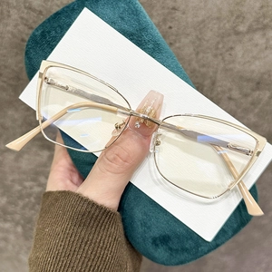 Classic metal frame glasses in gold with champagne tips on a luxury green velvet case