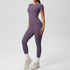 Detail view of purple yoga set showing high-stretch fabric and slim fit on a model
