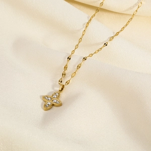 Detail of 18K gold-plated star pendant with sparkling crystals on elegant satin