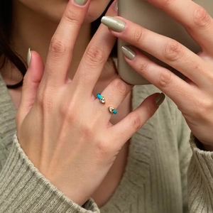 Close-up of adjustable 18K gold plated ring with turquoise enamel and zircon stones