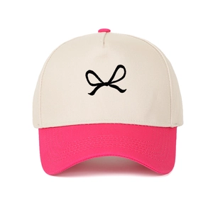 Vintage two-tone beige and pink trucker hat featuring a minimalist bow embroidery