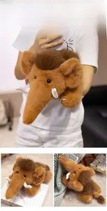 Close-up of mammoth plush toy with long brown fur, curved tusks and realistic details