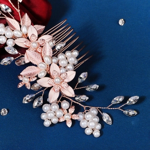 Elegant rose gold bridal hair comb featuring pearls and crystal floral design decorations