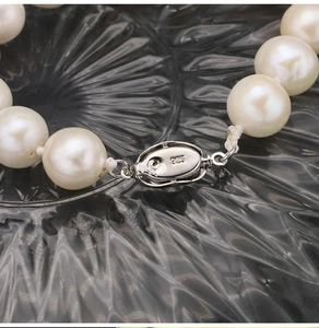 Macro shot of S925 silver clasp with 925 engraving on natural pearl bracelet