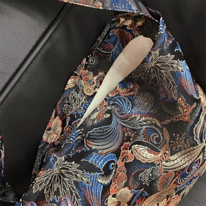 Detail of vintage floral brocade bag with bronze magnetic buckle and interior storage