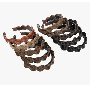 Macro view of wide braided headband styles in brown, black and auburn synthetic fiber