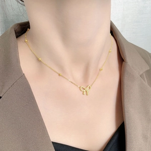 Elegant 18K gold bow necklace for women featuring a sparkling dainty bead chain