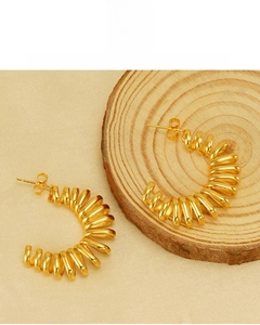 Detail of 18k gold plated spiral hoop earrings featuring lead and nickel free materials