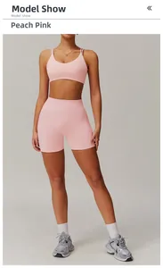 Detailed view of peach pink high-waist seamless shorts and cross back sports bra set