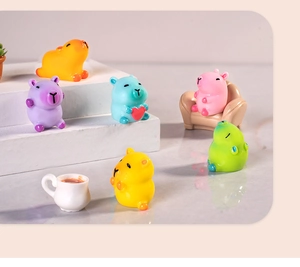 Detailed view of colorful resin Capybara figurines in orange, purple, blue, and pink