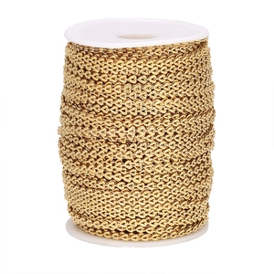 Macro detail of 4mm golden heart-shaped stainless steel chain on a white spool