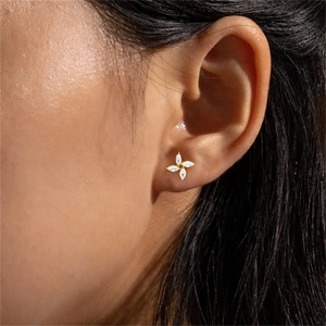 Close-up of a luxury s925 silver gold-plated stud earring with marquise-cut zircons