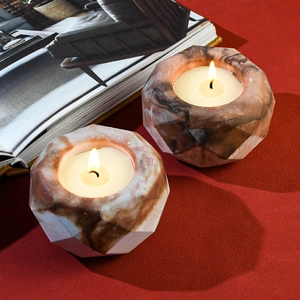 Faceted marble geometric candle holders set with burning tea lights for home decor