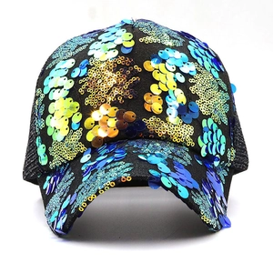 Detail of colorful sequins on a black mesh baseball cap showing glossy metallic texture