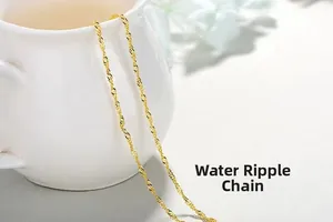 Detail shot of a golden water wave chain necklace with a spiral link design on white porcelain