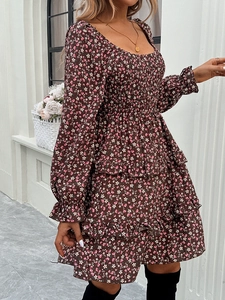 Detail of floral long sleeve dress with shirred bodice and layered tier skirt