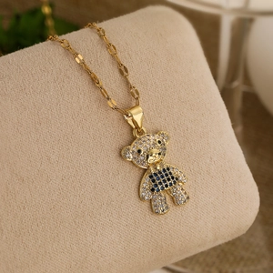 Luxurious gold-plated teddy bear pendant necklace with sparkling zircons on jewelry display