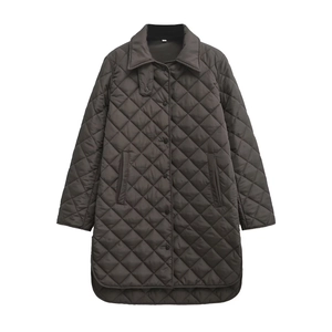 Detail of dark brown quilted cotton coat featuring a lapel collar and button closure