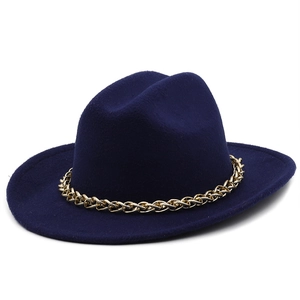 Detail of navy blue wool felt fedora featuring a decorative gold metal chain hatband