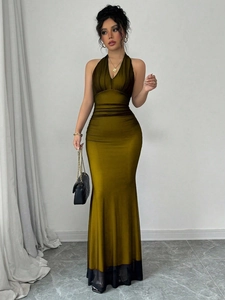 Detail of olive green satin halter dress featuring ruched waist and chiffon hemline