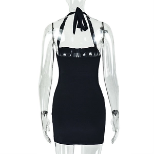 Detail of backless halter tie design and elastic fabric texture on a slim black mini dress