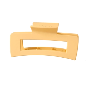 Close-up of a large pale yellow matte rectangular hair claw clip for elegant styling