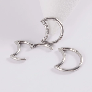 Surgical steel moon-shaped nose ring with sparkling cubic zirconia on white background