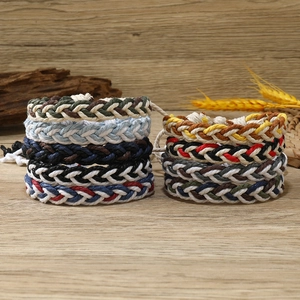 Detailed view of multiple colorful braided cotton rope bracelets in various sport patterns