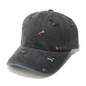 Detail of dachshund embroidery on washed dark gray baseball cap with vintage texture