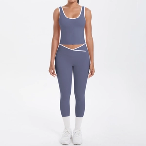 Macro shot of high-waist yoga pants and racerback top with white contrast piping