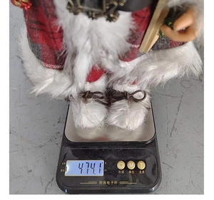 Standing Santa Claus plush in red plaid outfit on an electronic scale weighing 474.1g