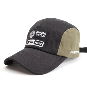 Detail of 5-panel cap featuring grey and olive green contrast with high-quality embroidery