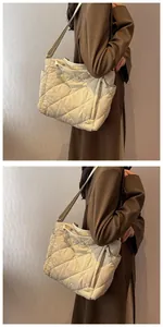 Quilted tote bag detail showing khaki water-resistant nylon texture and side drawstring pocket