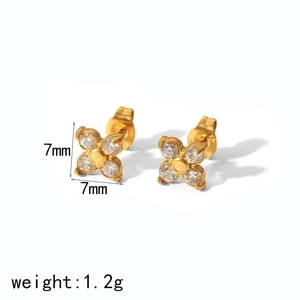 Detail shot of 18K gold clover studs with zircon inlay and 7mm size specification