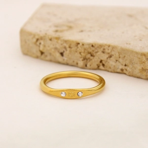 Macro detail of gold Cancer zodiac ring featuring engraved symbol and tiny diamond accents