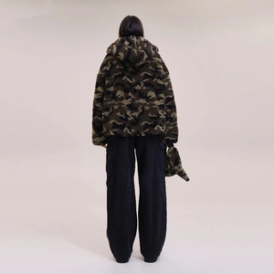 Rear view of camouflage faux fur hoodie and black wide-leg trousers on model