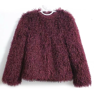 Detail of burgundy faux fur coat showing soft plush texture and round neckline
